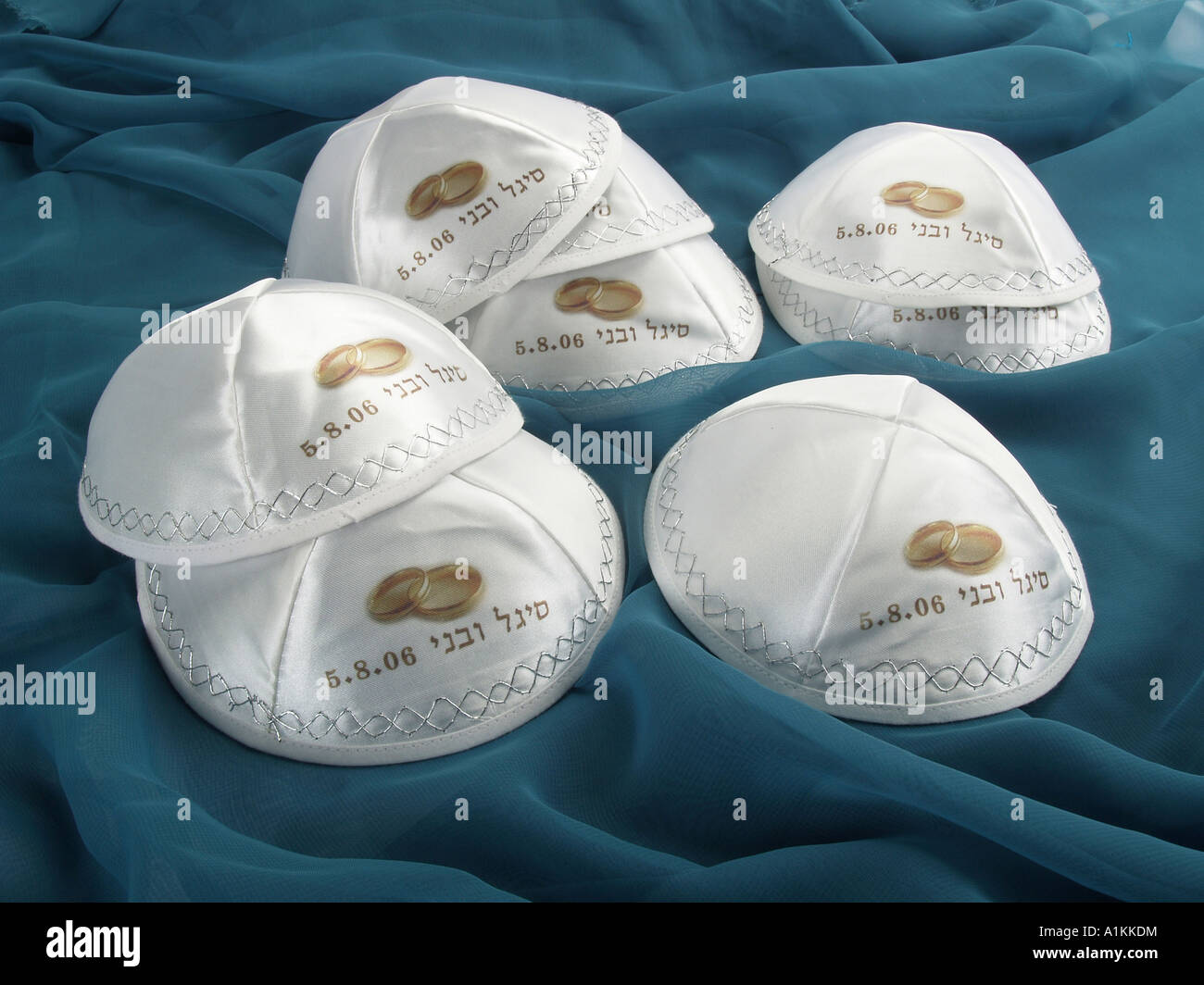 Jewish kipoth skullcaps with text in gold on fabric background Stock Photo