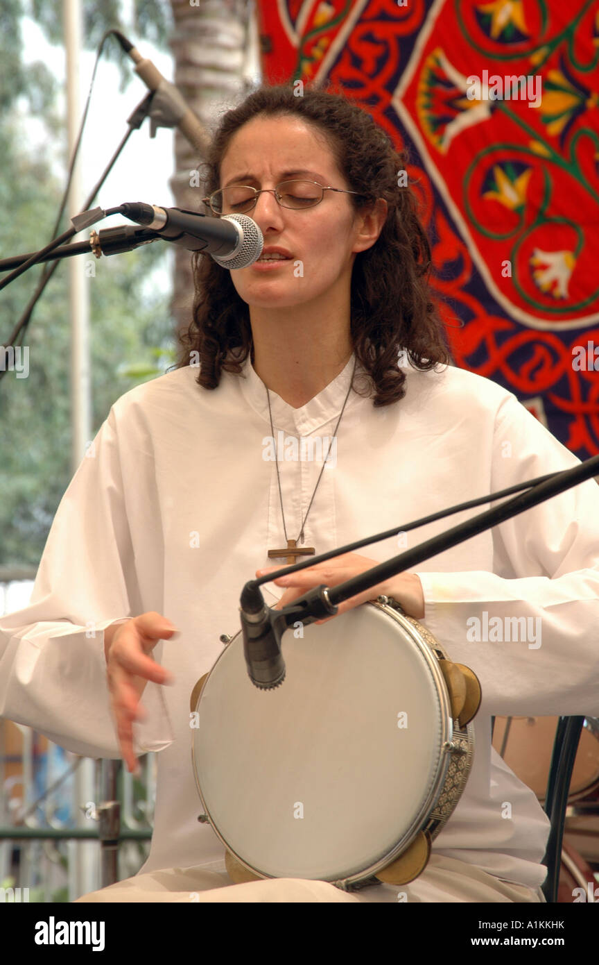 Female artist drumming on a Darbuka live on stage at the Jacob s ladder