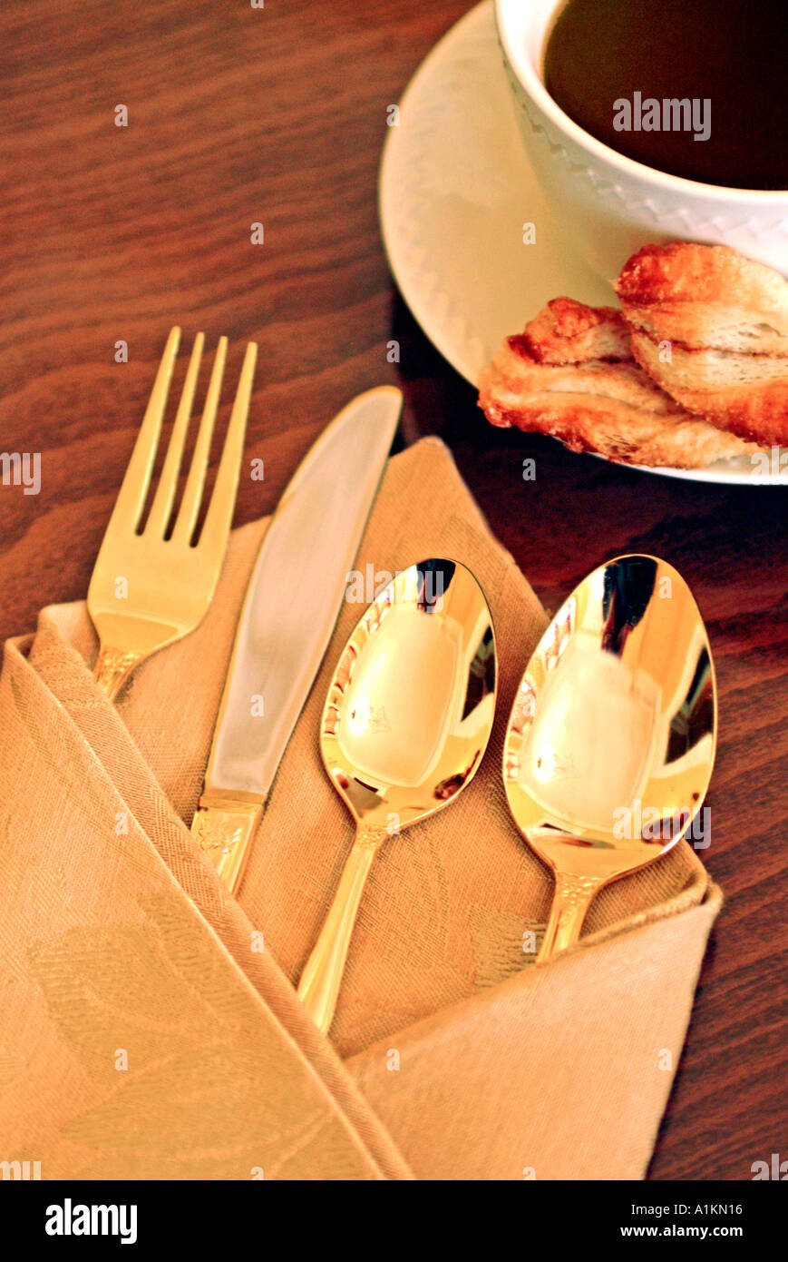 gold flatware on table place setting Stock Photo Alamy