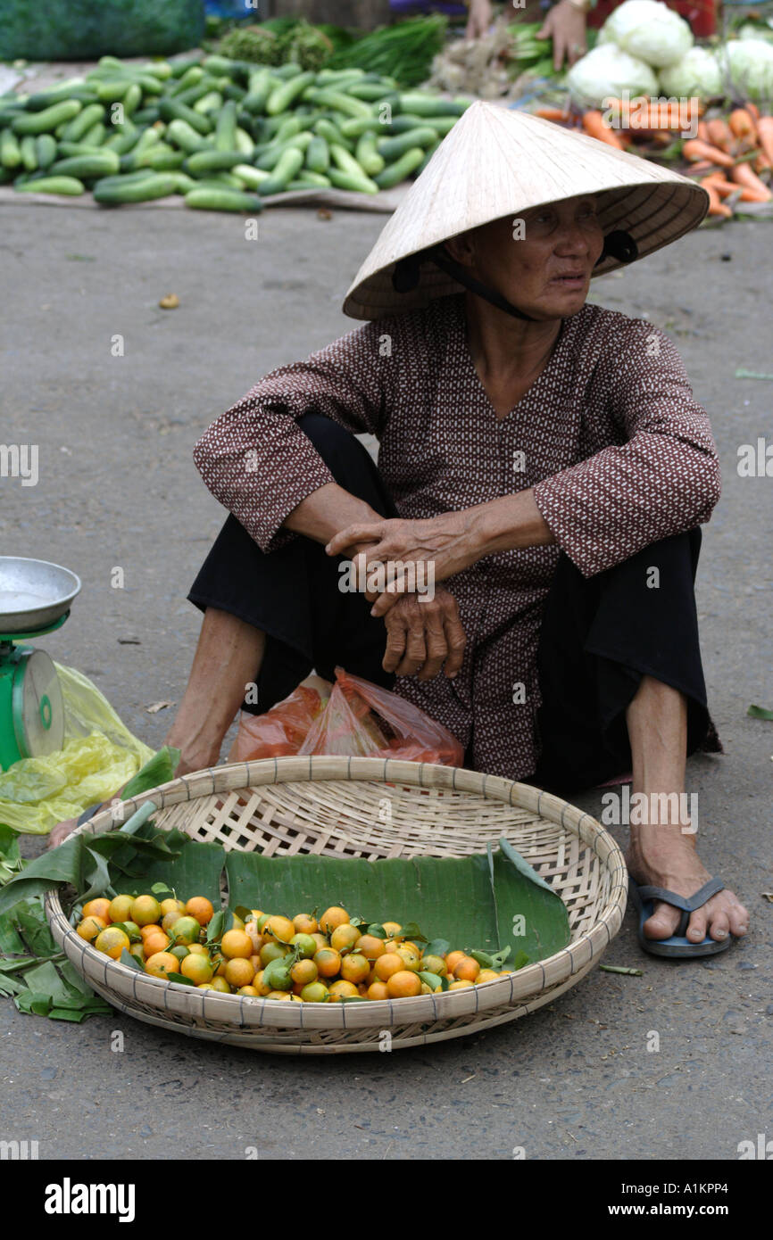 Woman sells fruit and vegetables in Vihn Long, Mekong Delta, Vietnam Stock Photo