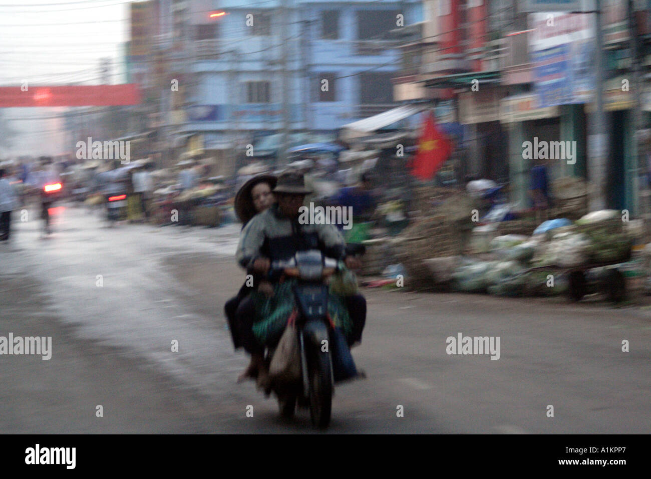 Man and woman on a motorbike in Vihn Long, Mekong Delta, Vietnam Stock Photo