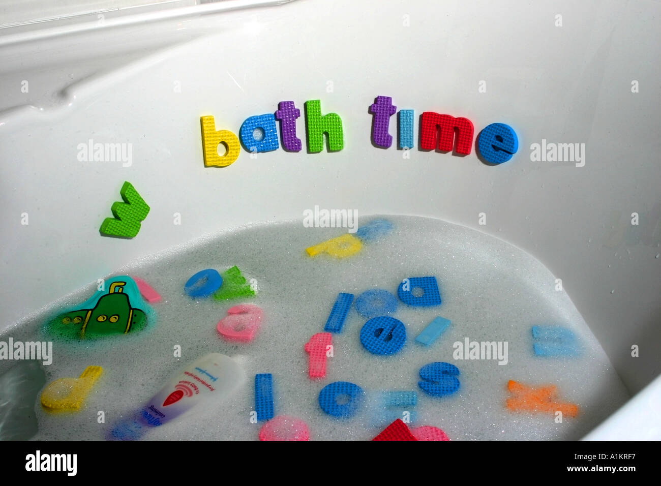 Baby in bath with lettering implying extra intelligence Baby bathtime