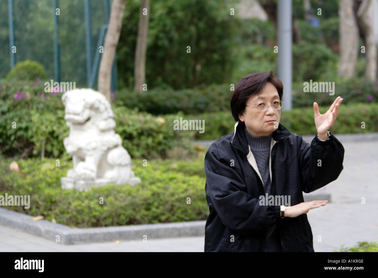 Woman in Victoria Park practices traditional exercise, Hong Kong Stock Photo