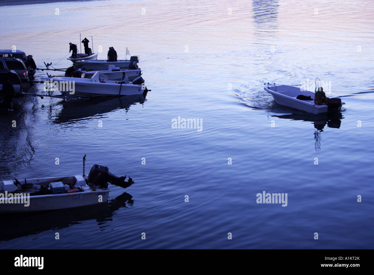 Silhouette of people fishing in kuwait harbor kuwait city Stock Photo