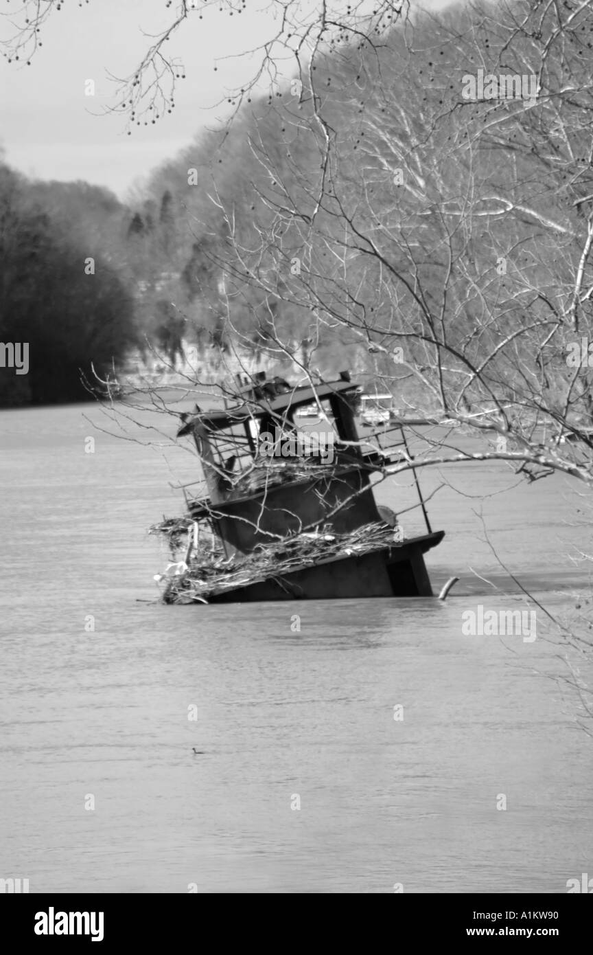 Black and white image of an old rusting sunken tugboat in the Kentucky River USA Stock Photo