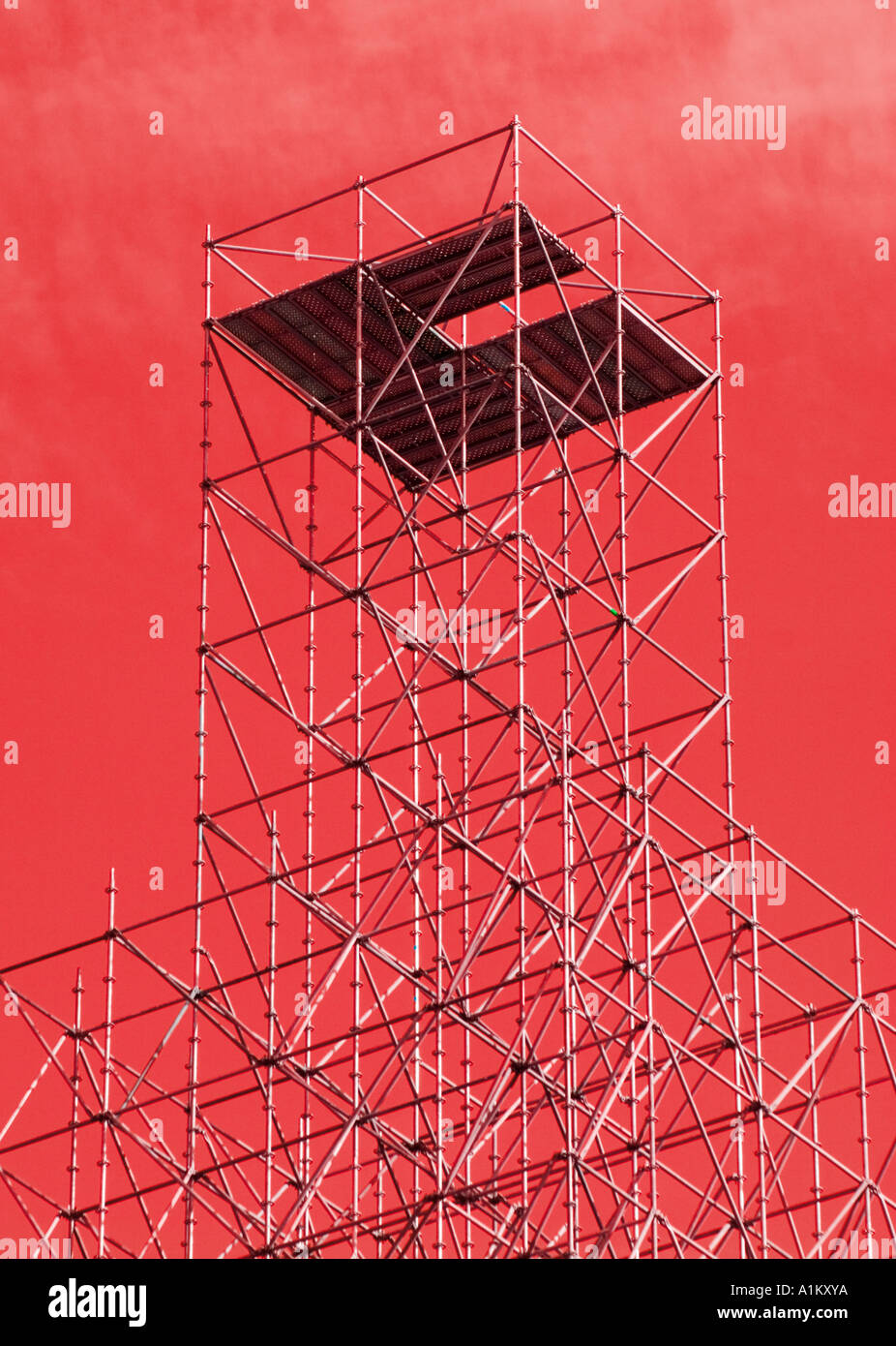 Scaffolding tower against abstracted red sky Stock Photo