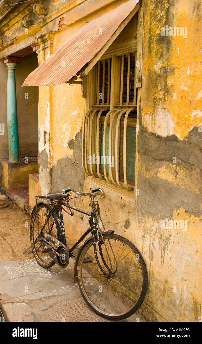 A rickety bicycle rests next to an old colonial house in Pondicherry ... - A Rickety Bicycle Rests Next To An OlD Colonial House In PonDicherry A1M0FG
