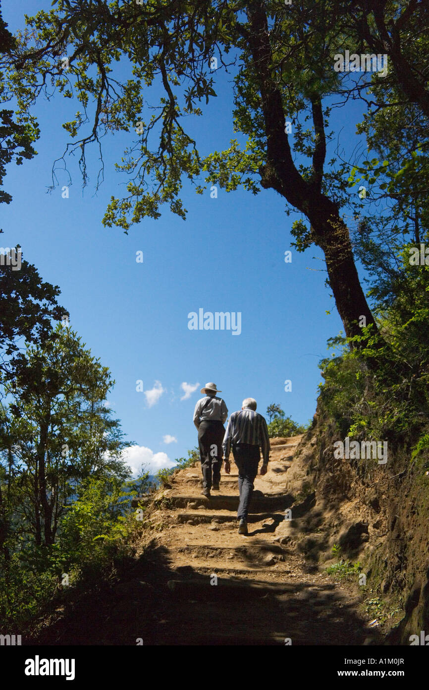 Western traveler hike on trail to Taktsang (Tiger's Nest) Monastery Paro Bhutan Stock Photo