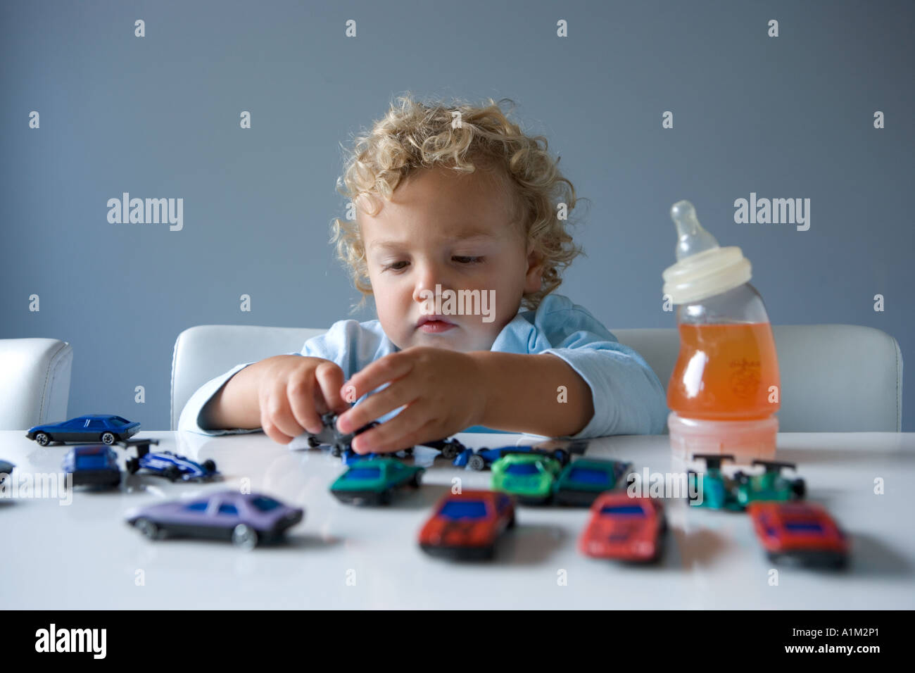 Little boy playing with toy cars Stock Photo - Alamy