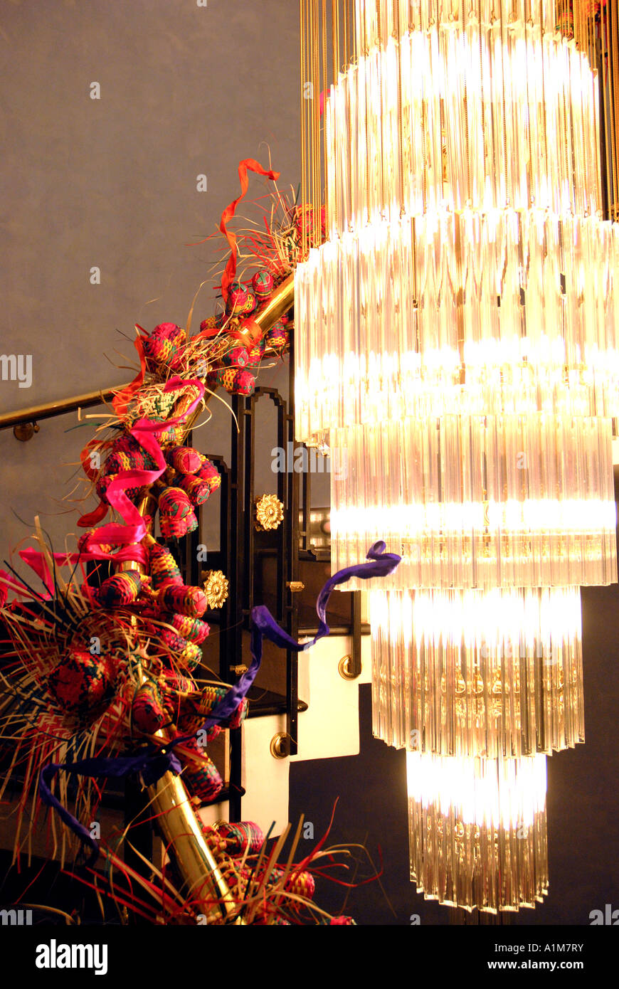 Christmas Decorations On A Spiral Staircase With A Chandelier