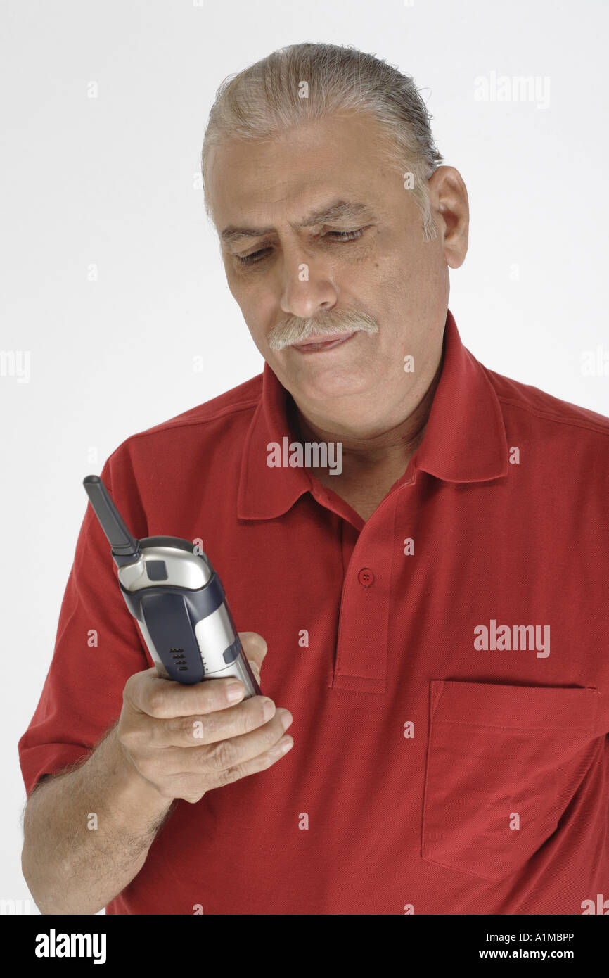 Man Using Red Telephone ANG201185 Old man holding cordless phone and dialing wearing red ...