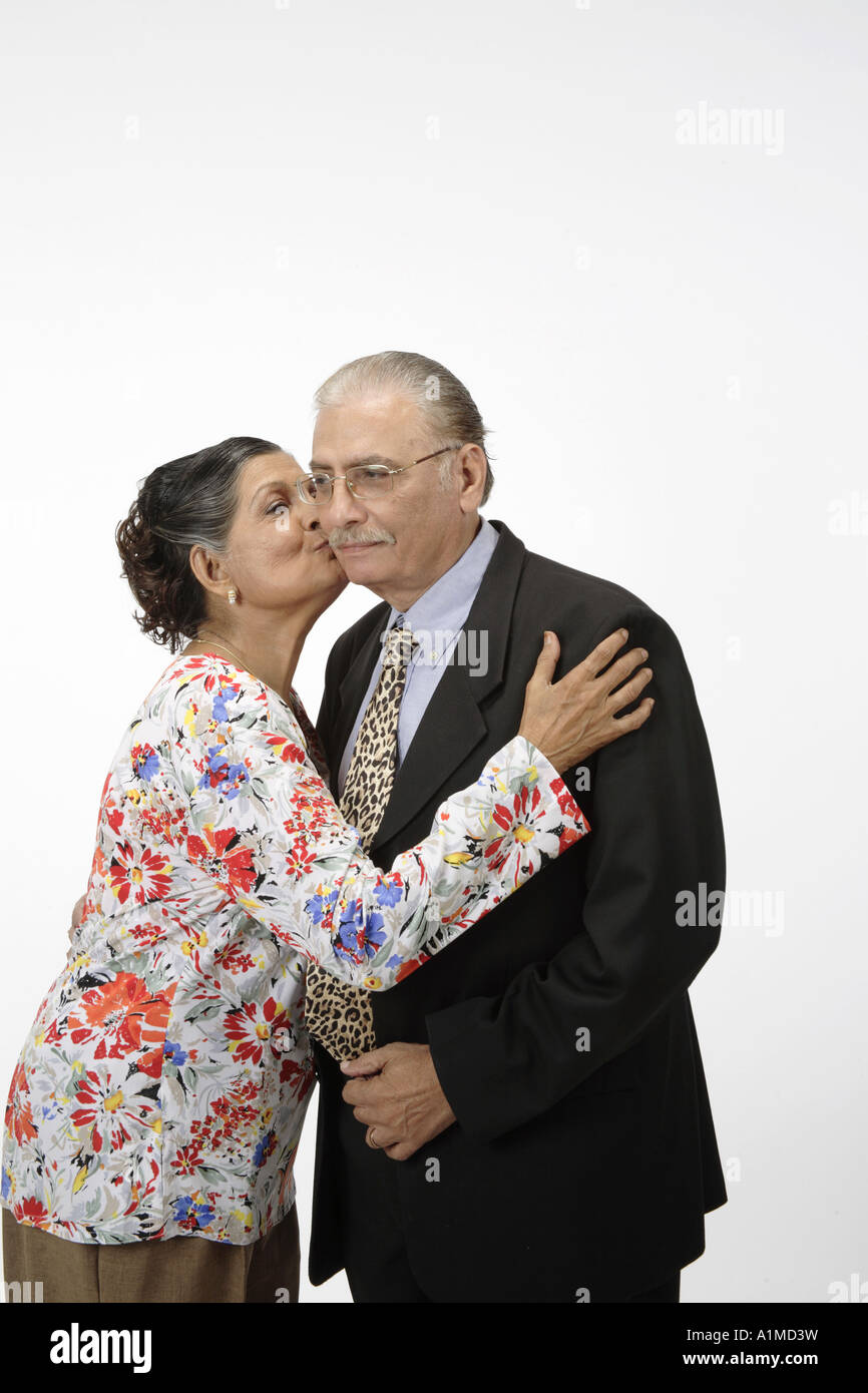 Loving Indian senior citizen couple wife kissing husband on cheek Stock Photo