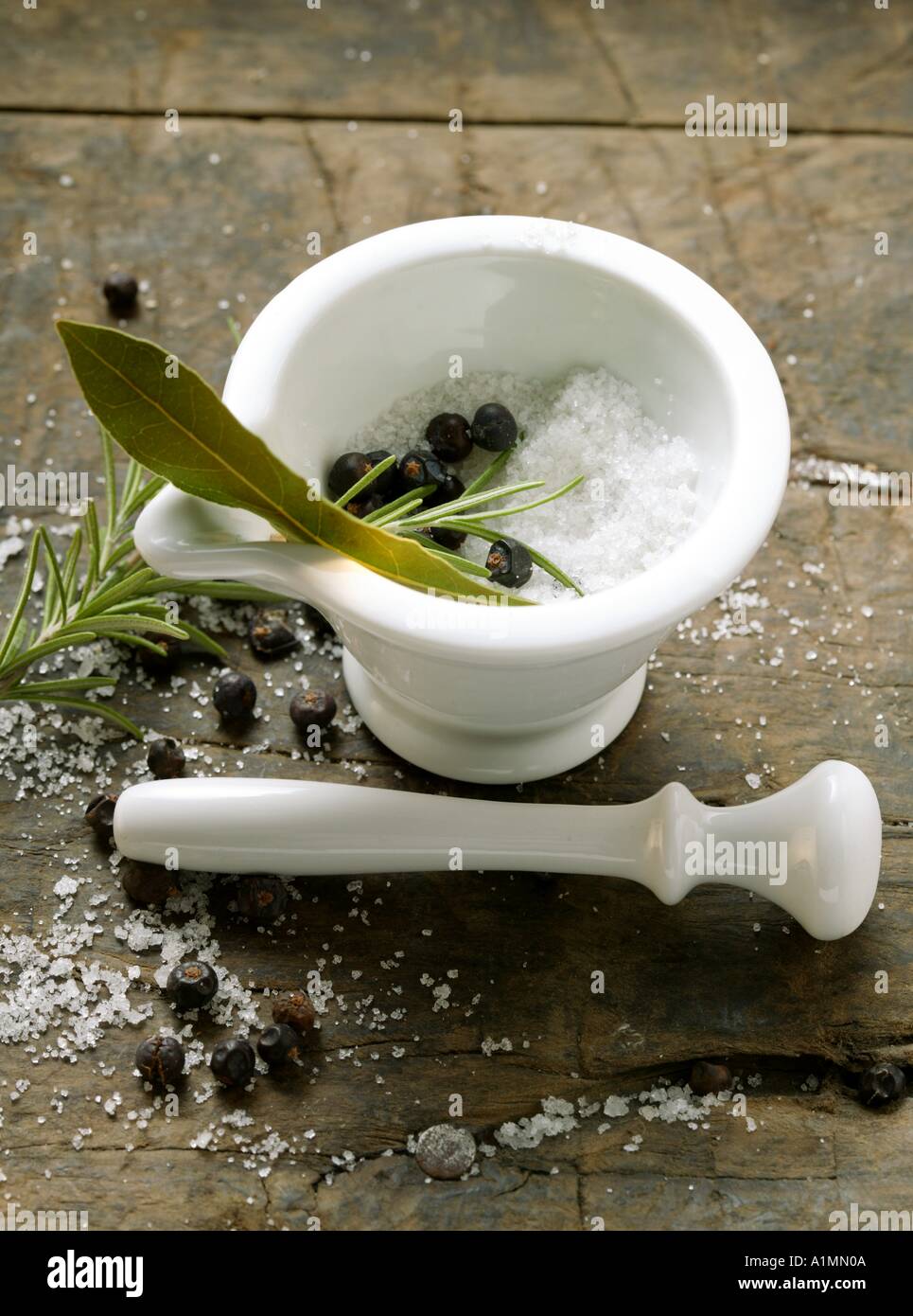 Salt juniper berries rosemary and bay leaf in mortar Stock Photo Alamy