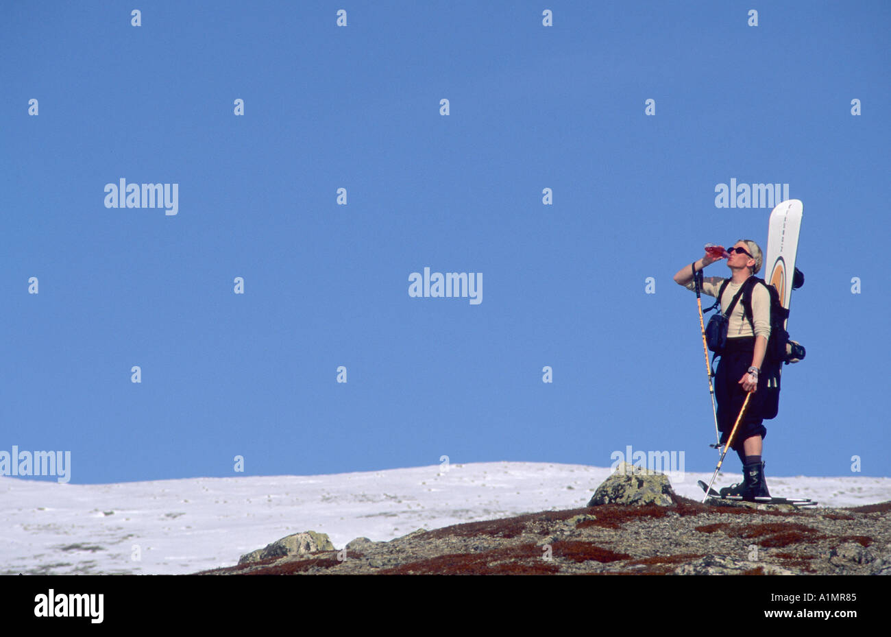 Snowboard walker drinking water Stock Photo Alamy