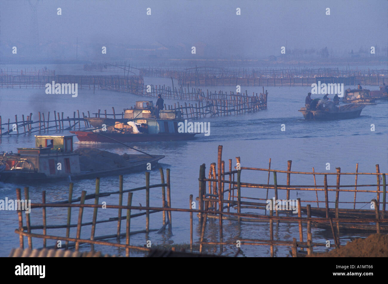 Bamboo fence for fishing and boats on the Grand Canal in the watertown South China Stock Photo
