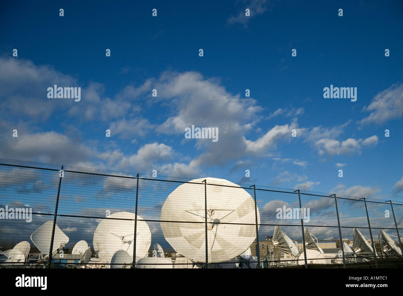 Array of satellite dishes pointing skywards Stock Photo
