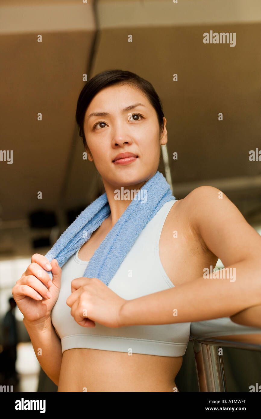 Young woman leaning on a ballet bar Stock Photo