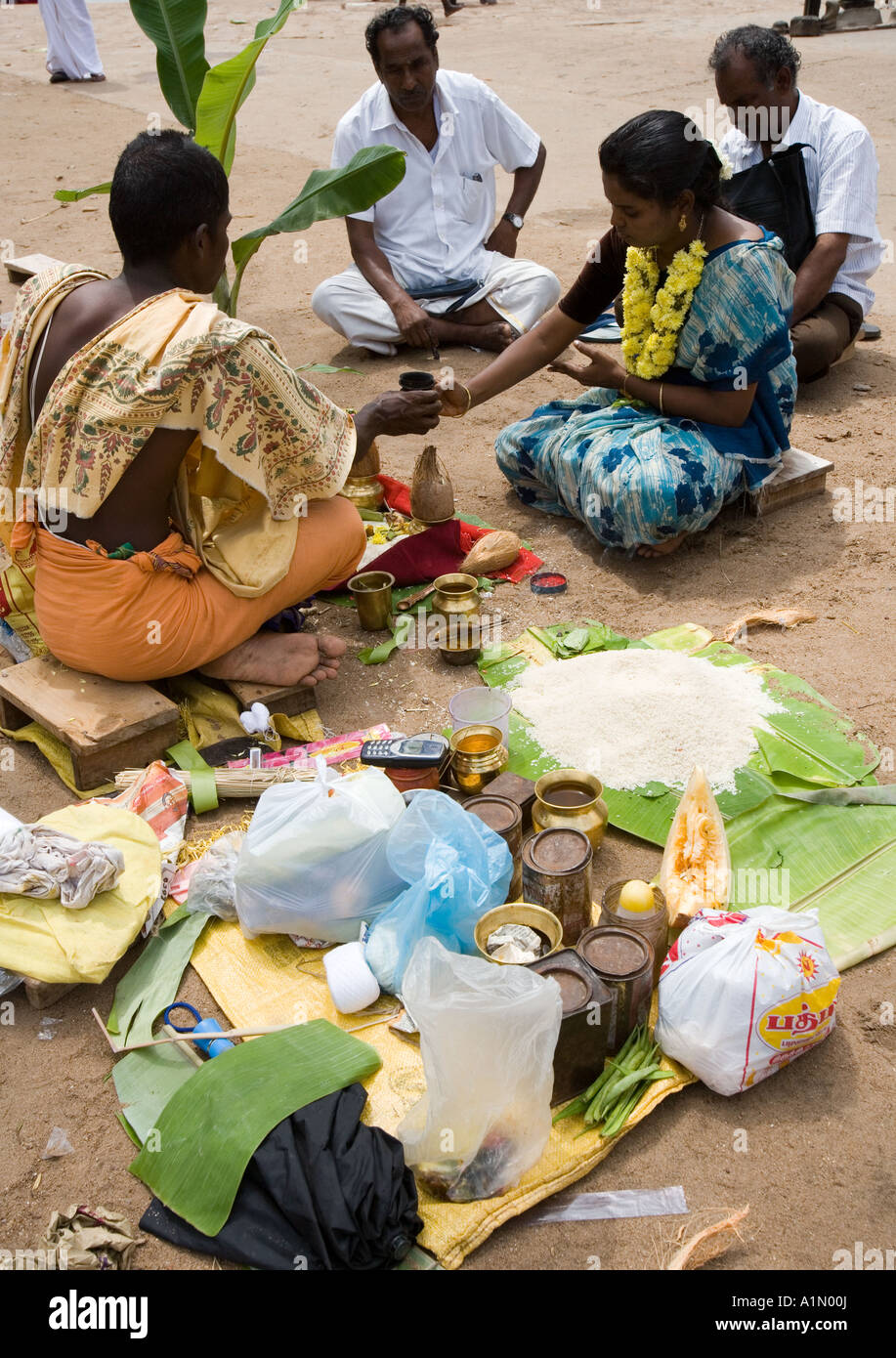 Local people at prayer in Srirangam near Tiruchirapalli in the Tamil Nadu region of Southern India Stock Photo