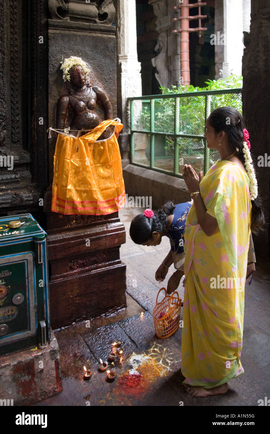 Pregnant Indian women pray for a safe birth to a Hindu deity at the