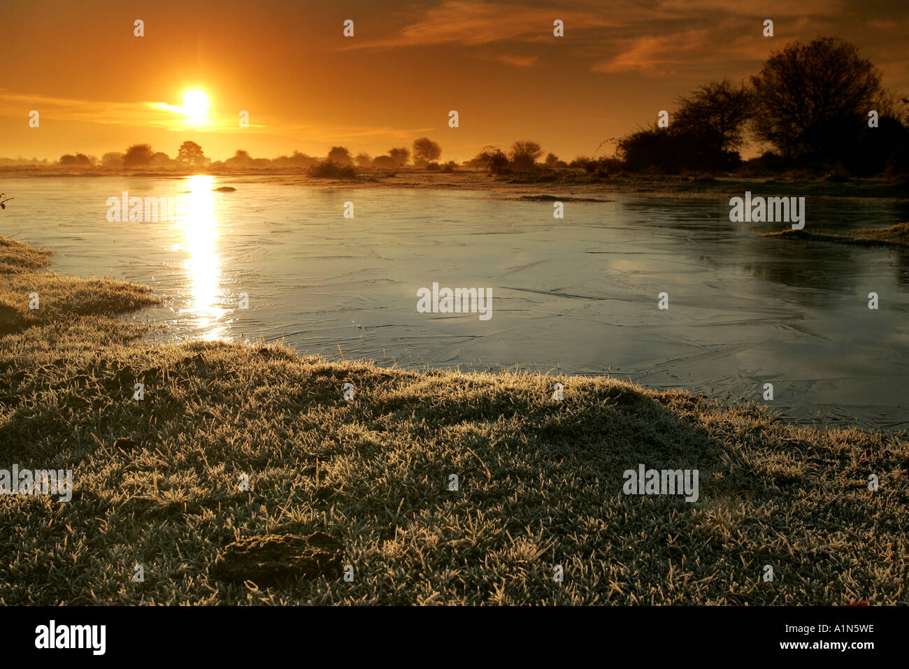 SUNRISE ON A FROZEN WINTER MORNING Stock Photo