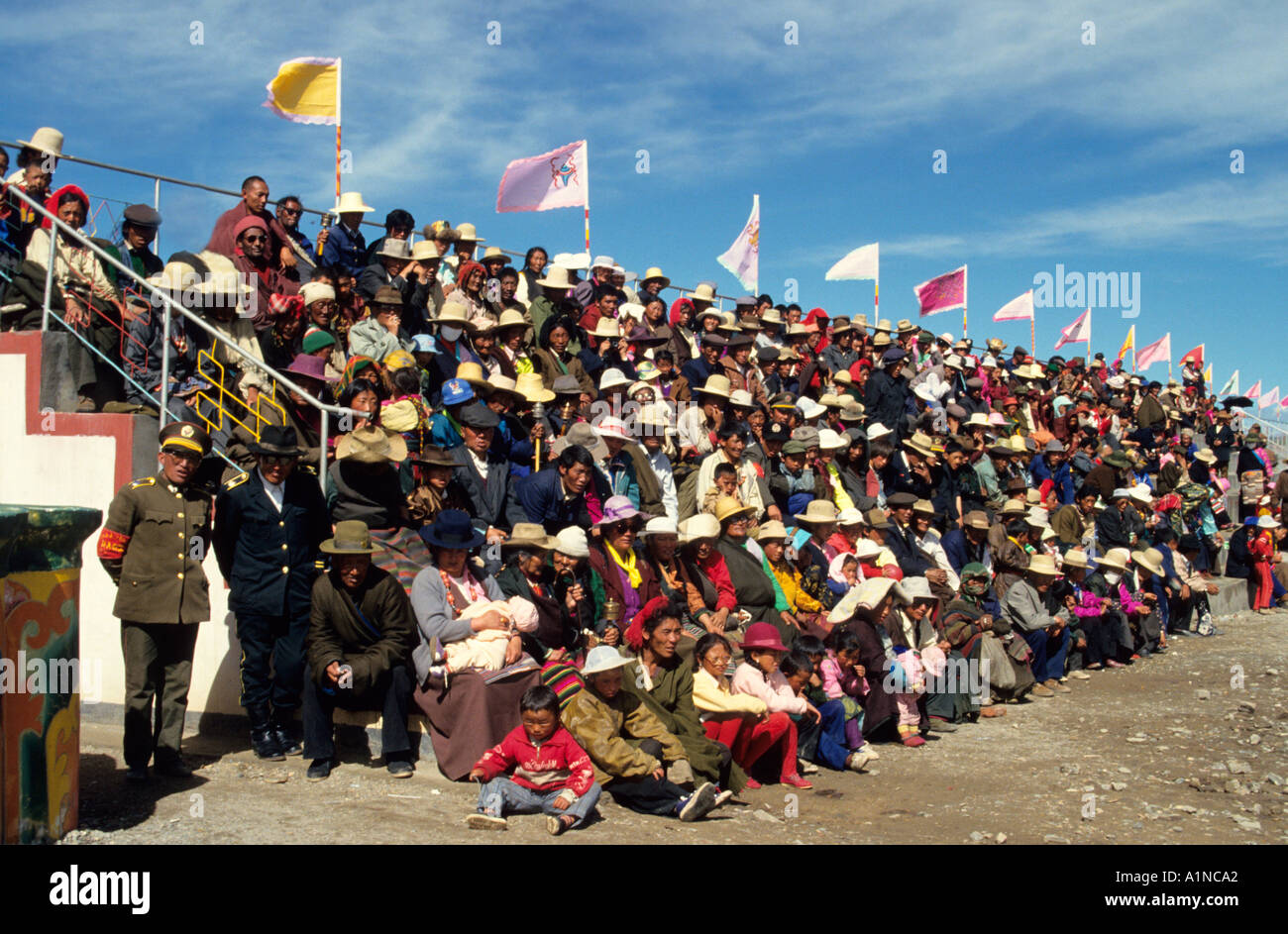 crowds watching the Naqu Horse fair held annually in Northern Tibet watched by Chinese soldiers Stock Photo