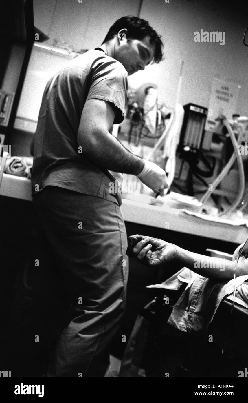 A doctor treating a patient in the Trauma Unit at the Accident and Emergency A E department of the Royal  London Hospital. Stock Photo