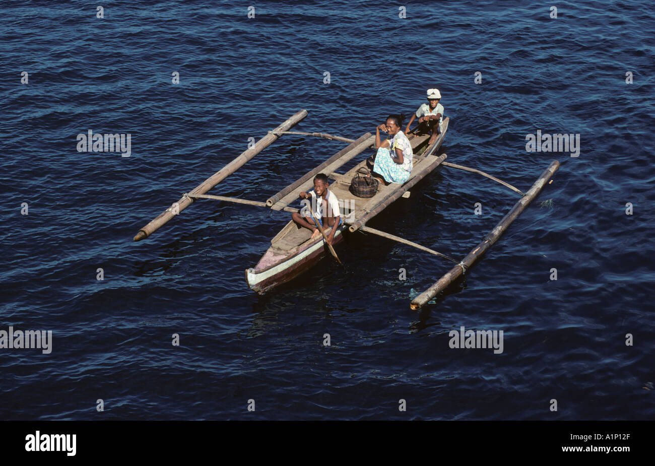 Badjao Badjau or Tau Laut sea gypsies Basilan Island Mindanao Philippines In outrigger canoe Dive for coins thrown into the wate Stock Photo