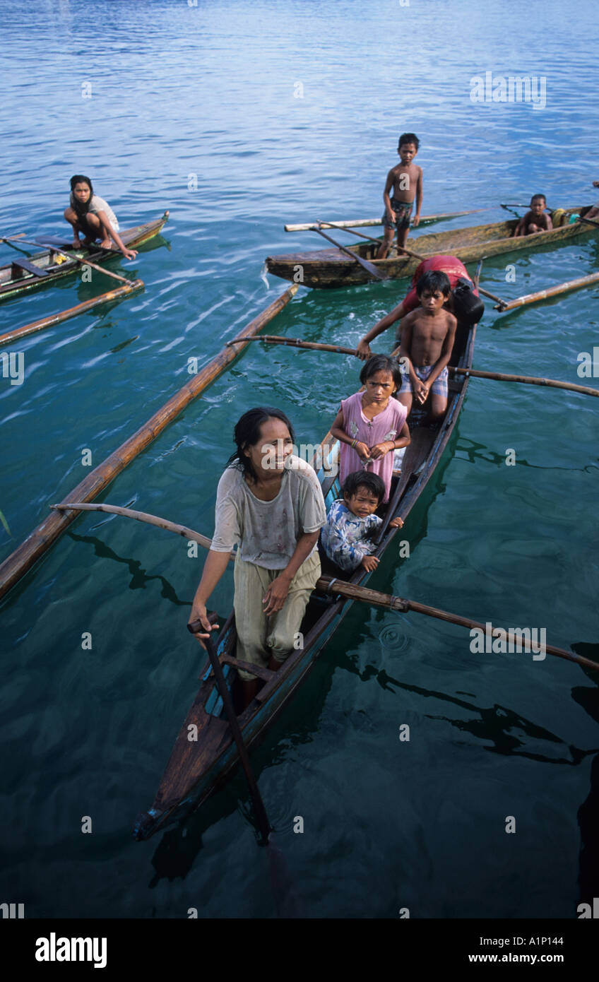 Badjao Badjau or Tau Laut sea gypsies children Puerto Princesa Palawan Philippines In outrigger canoe Dive for coins thrown into Stock Photo