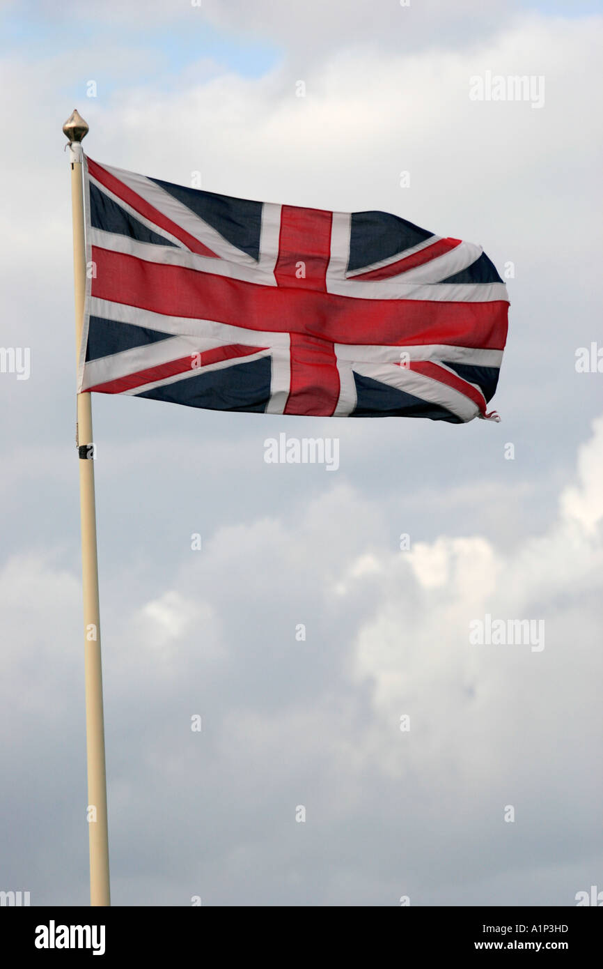 THE UNION JACK, THE FLAG OF THE UNITED KINGDOM, FLYING FROM A FLAGPOLE IN THE BREEZE. Stock Photo