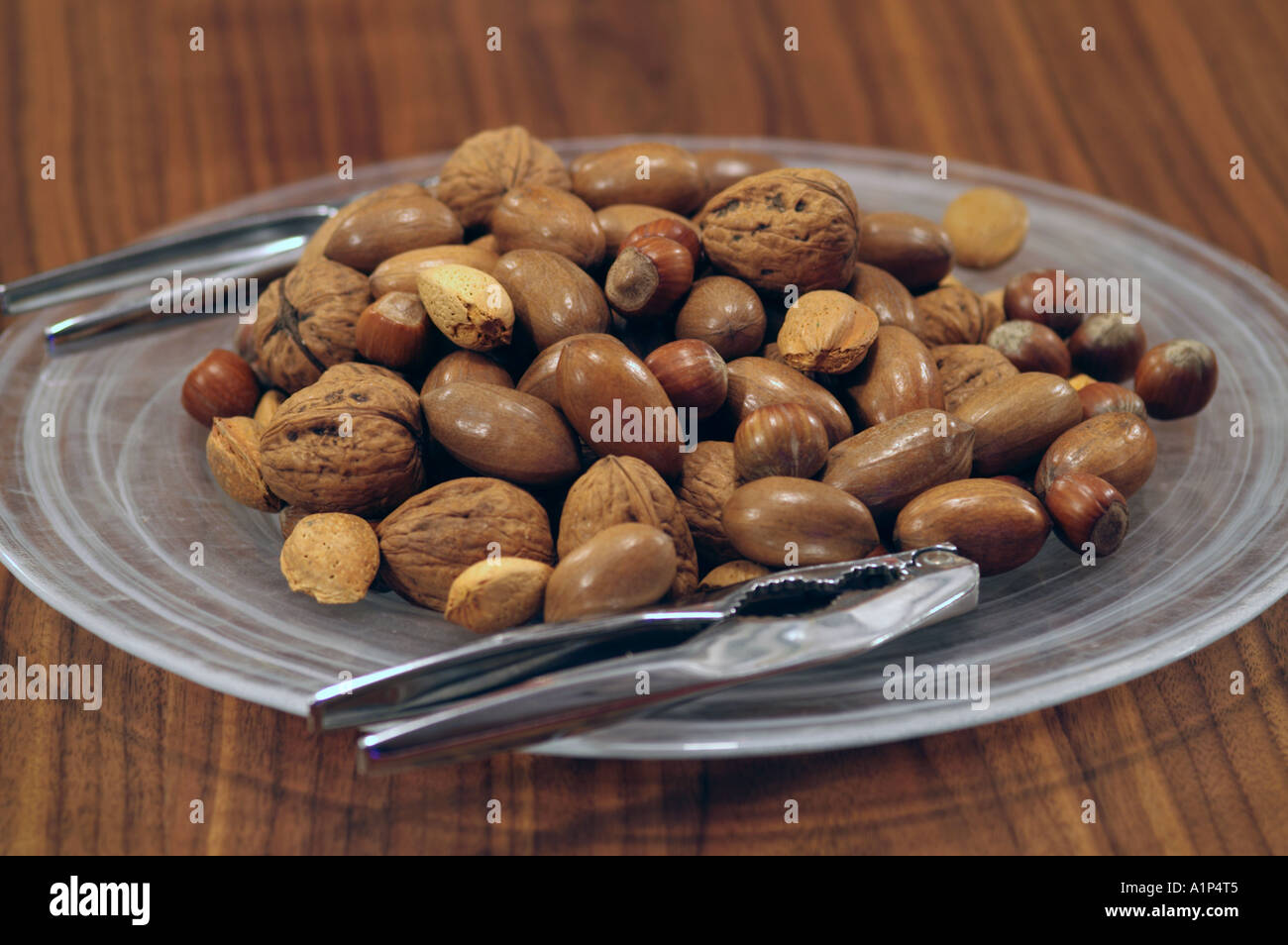 Mixed nuts on table with nut crackers Stock Photo Alamy