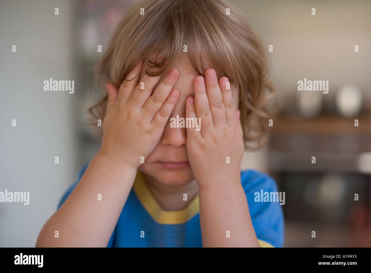 Young child covering eyes with hands Stock Photo Alamy