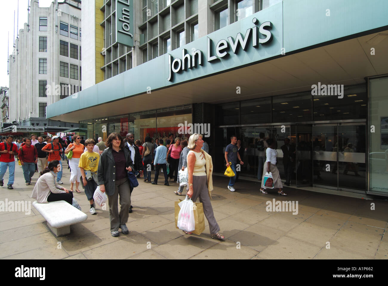 West End of London City of Westminster Oxford Street shoppers walking outside John Lewis department store frontage & canopy sign entrance England UK Stock Photo