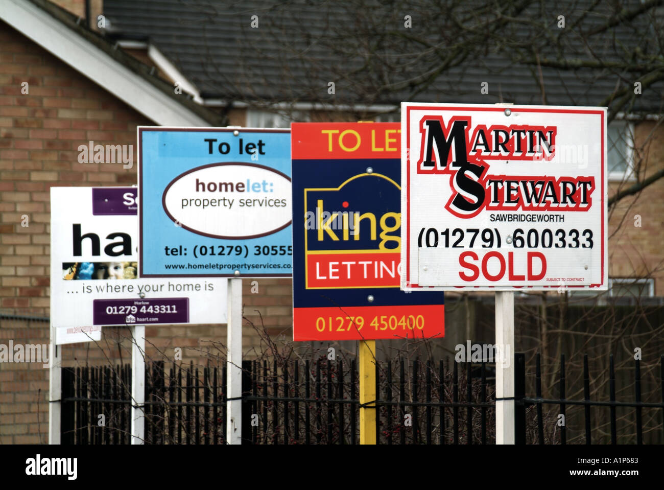 Harlow Essex estate agents letting agents and mortgage service providers advertising boards close to residential properties Stock Photo