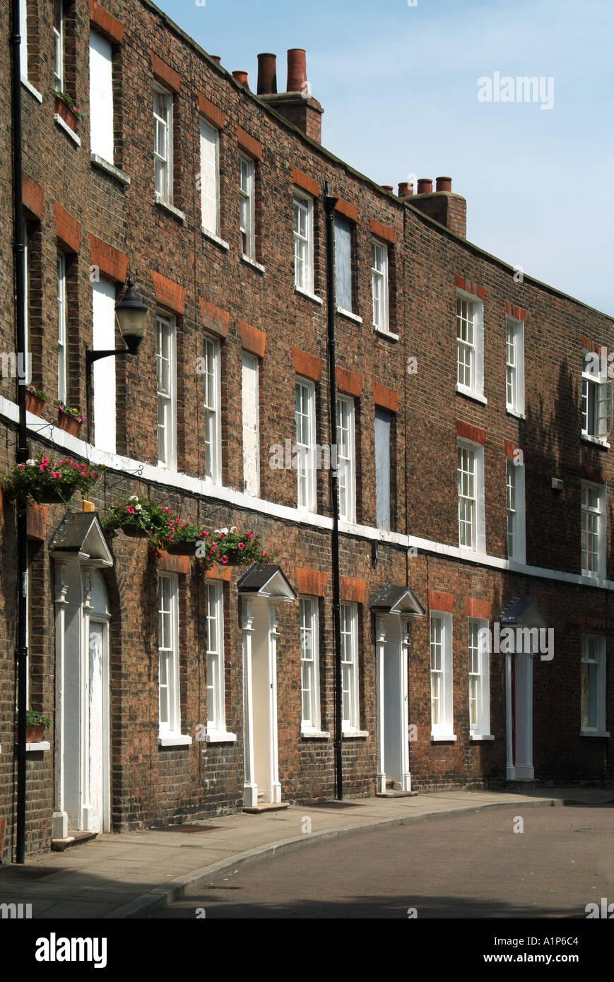 Wisbech curved row of terraced dwellings in Union Place with front doors opening directly onto pavement Stock Photo