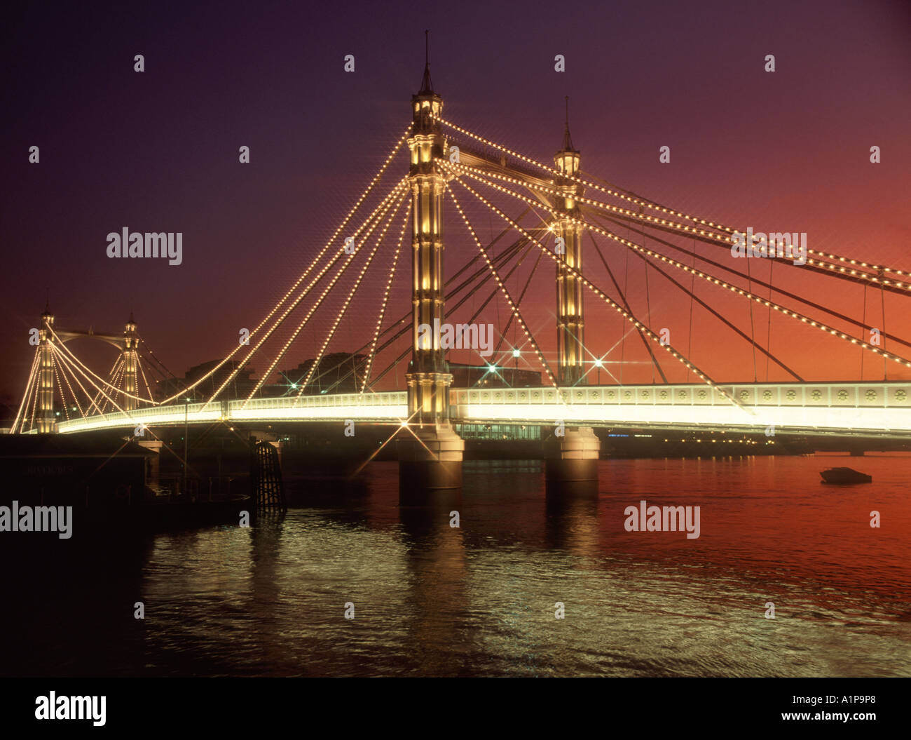 Sunset & lights at dusk on iconic historical Victorian Albert Bridge