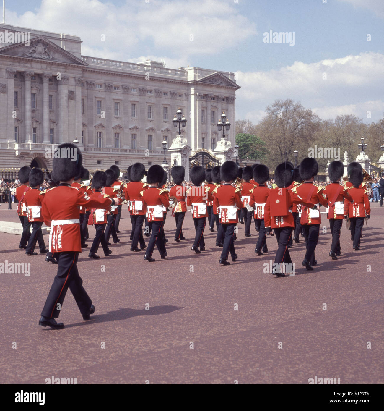 Tourists at changing guard ceremony back view men of British guards