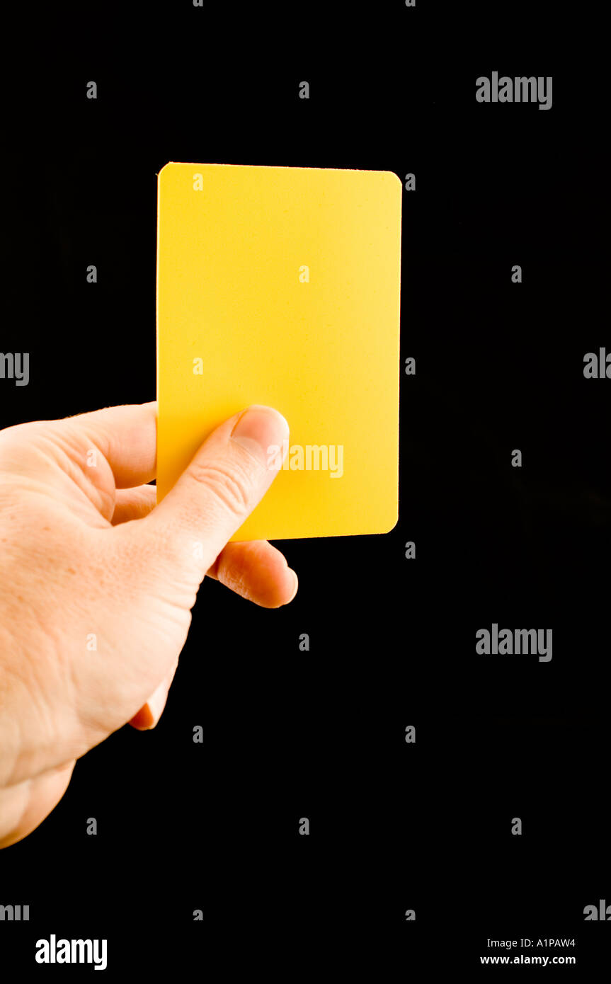 hand holding up a yellow card Stock Photo Alamy