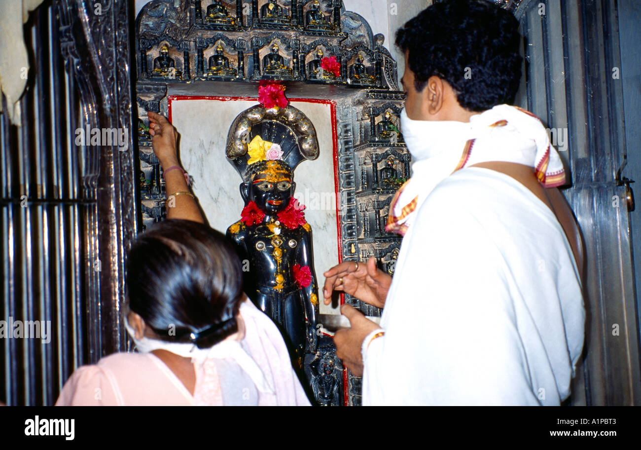 Malabar Hill Mumbai (Formerly Bombay ) India Adishwarji Jain Temple Devotees Placing Flowers On Idol Stock Photo