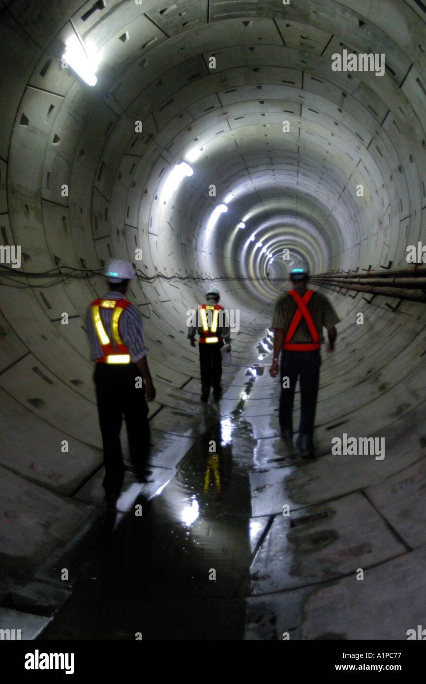 Workers are walking in underground tunnels during the construction of