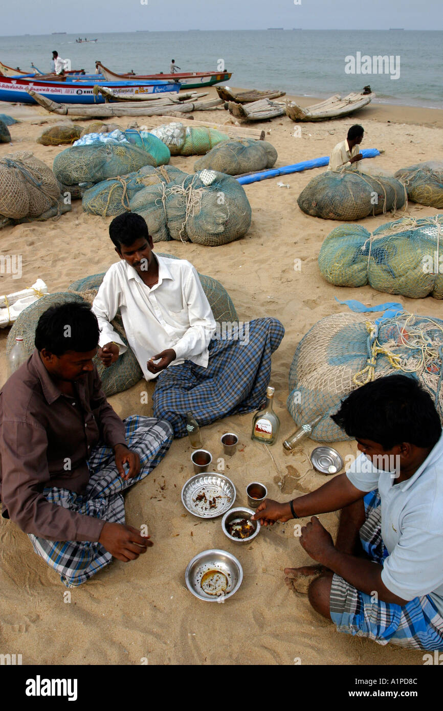 Fishermen play cards at the Marina Beach in Chennai Madras in India Stock Photo