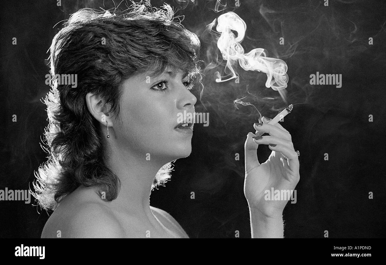 Young woman smoking a cigarette. Stock Photo