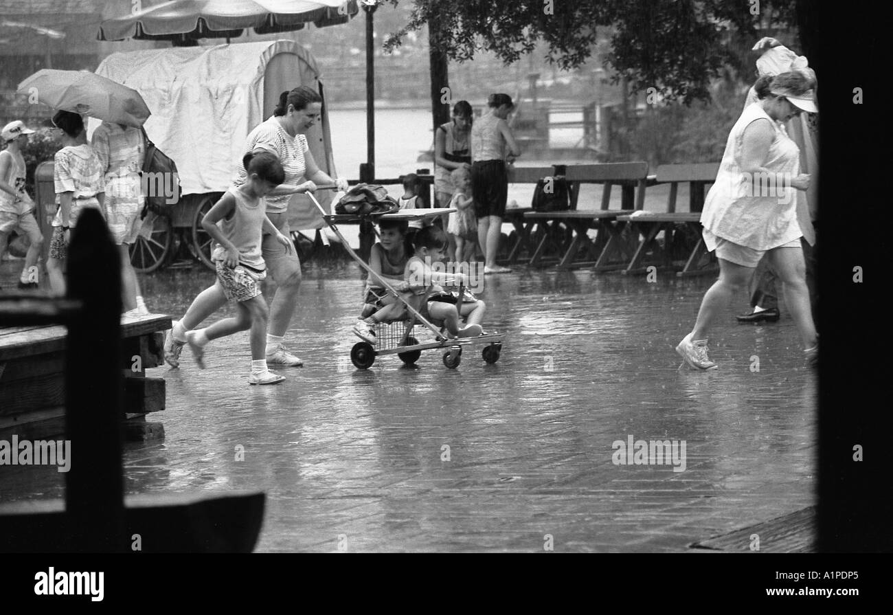 Heavy rain shower causing people to cover up or shelter at Magic
