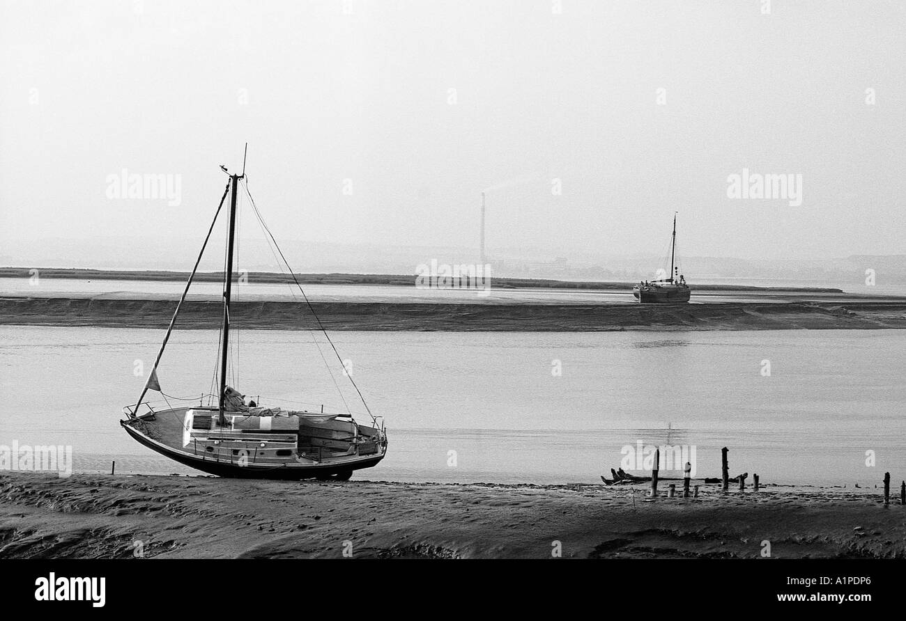 Two sailing vessels marooned on mud flats at low tide in the river Humber. Stock Photo