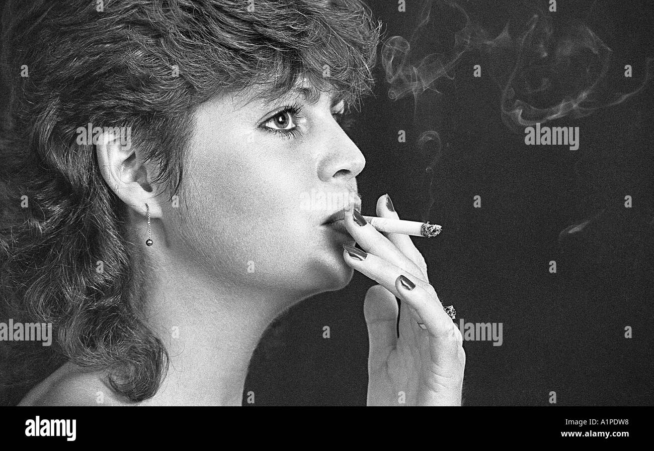 Young woman smoking a cigarette. Stock Photo