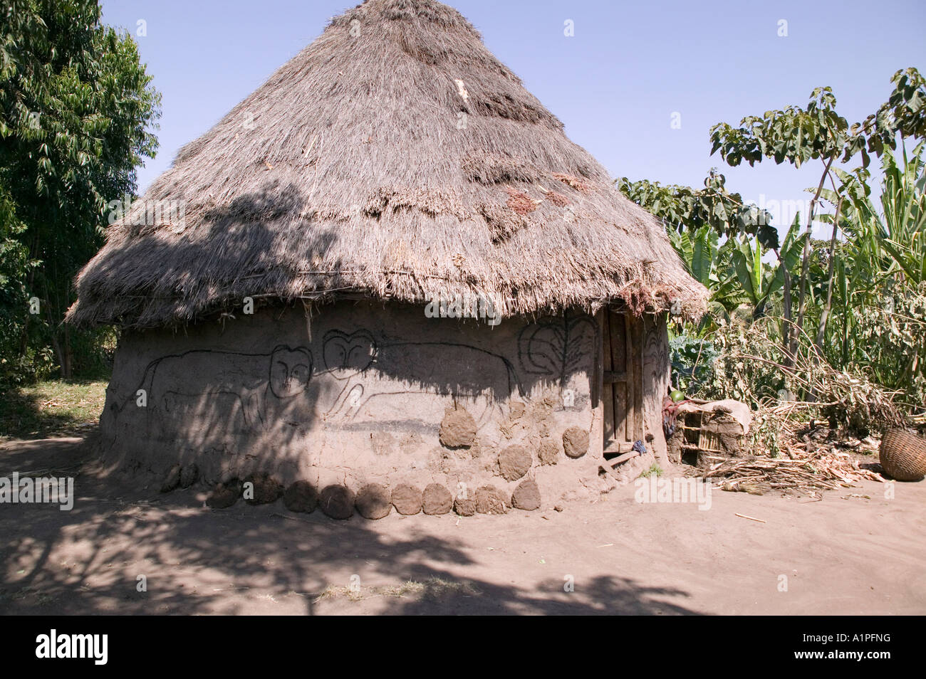 A round hut in rural Ethiopia with animal drawings on the side Stock Photo