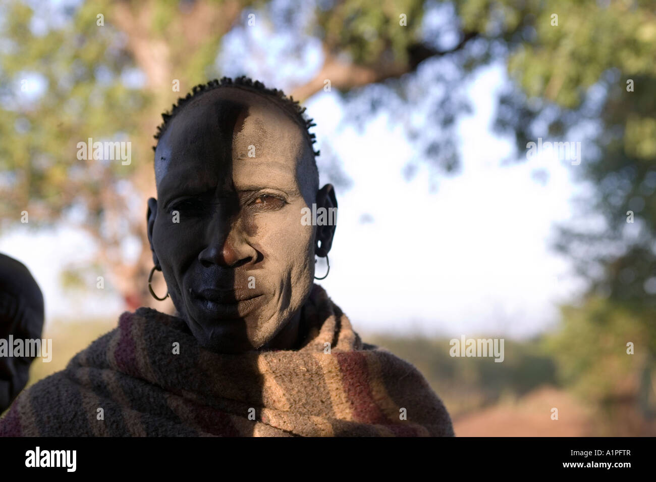 Man standing partially in the shade in Geia village in southern Ethiopia Stock Photo