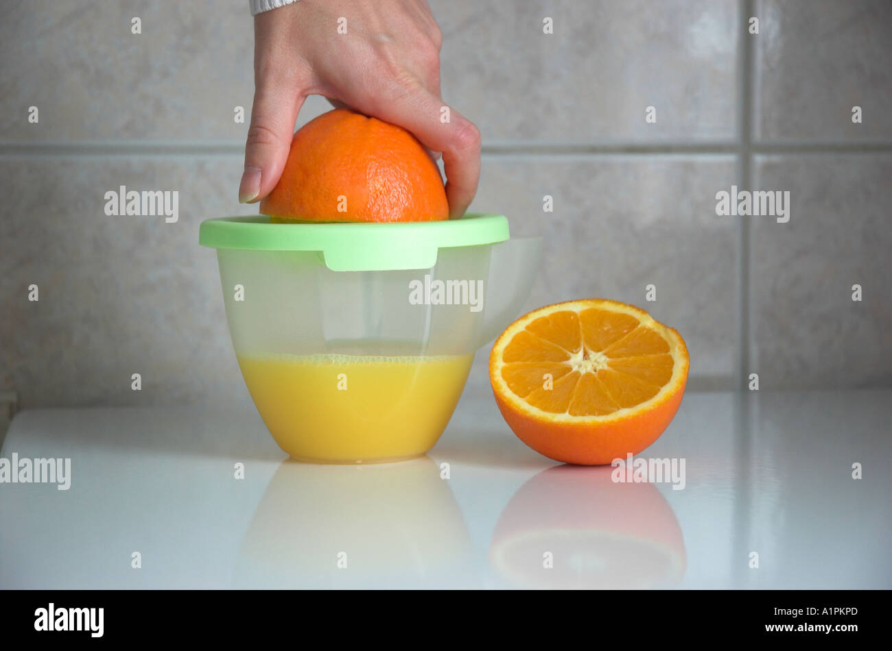 Hand squeezing an orange Stock Photo Alamy