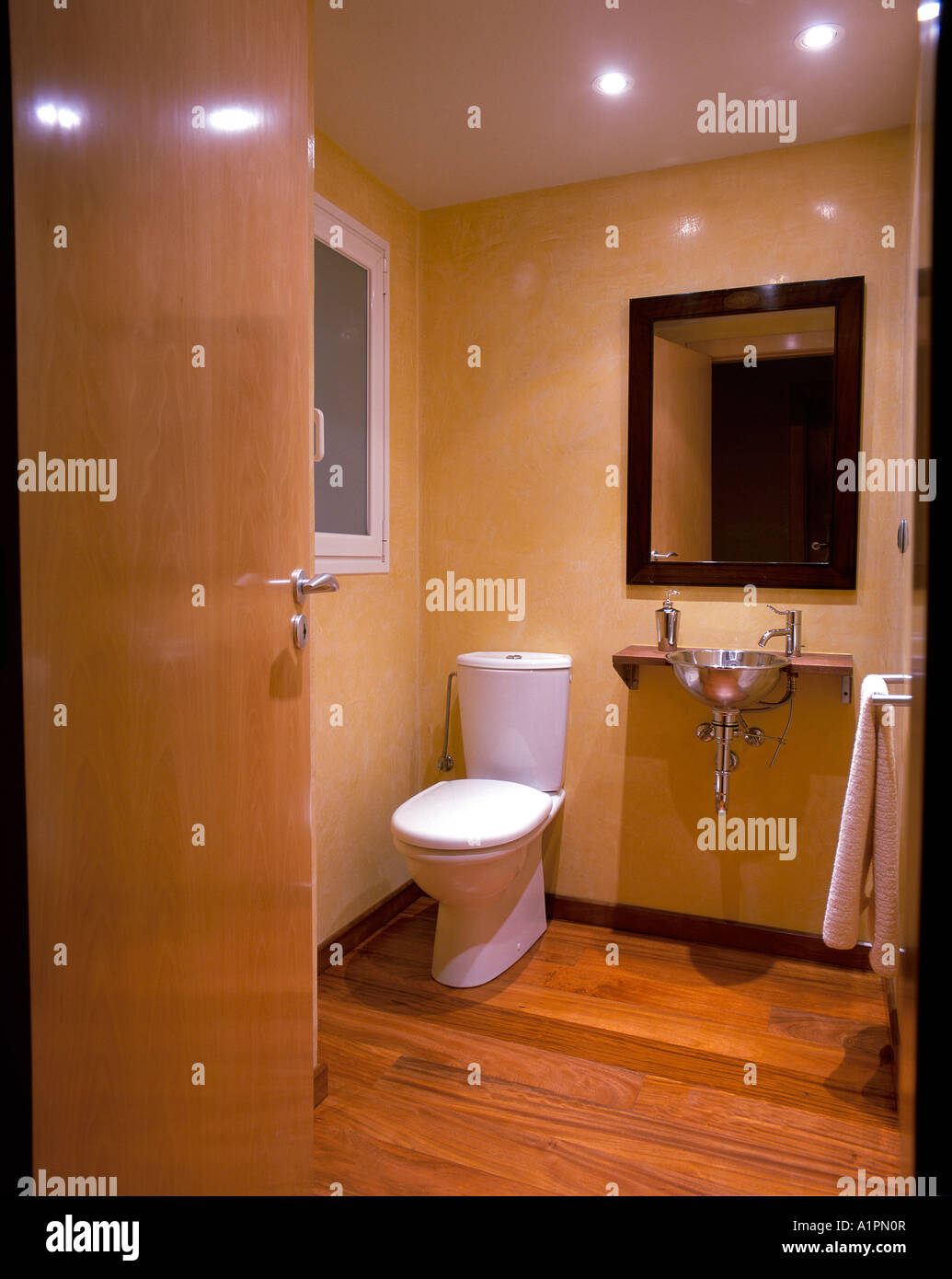 View of a toilet with hardwood flooring Stock Photo Alamy
