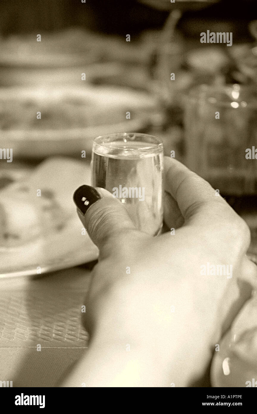 glass of vodka hold in hand Stock Photo Alamy