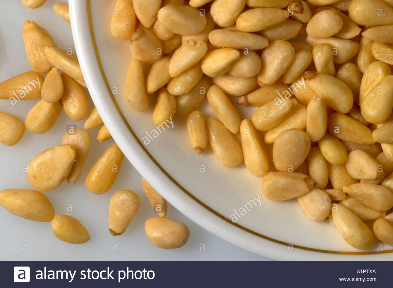 A number of pine nuts on a dish Stock Photo
